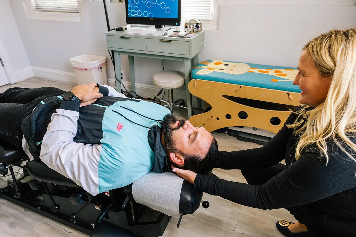 Dr. Kincaid cradling a patient’s head and neck before a cervical adjustment