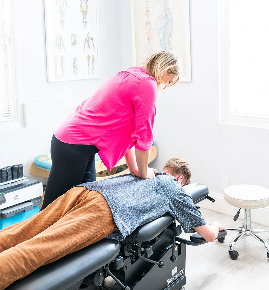 Dr. Elizabeth Kincaid adjusting a patient's mid-back at Bluebonnet Chiropractic in Tomball